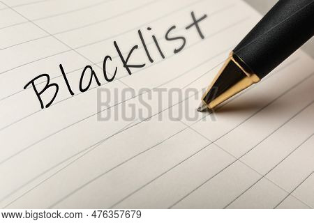 Writing Word Blacklist With Pen In Notepad, Closeup