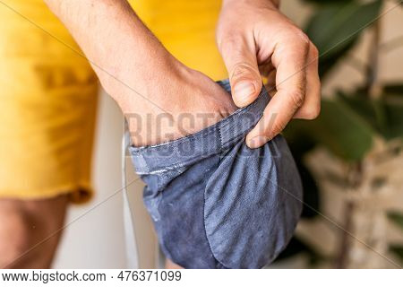 Hands Of A Rock Climber Close-up. The Man Puts His Hands In A Bag Of Magnesia. Men's Hands In Sports