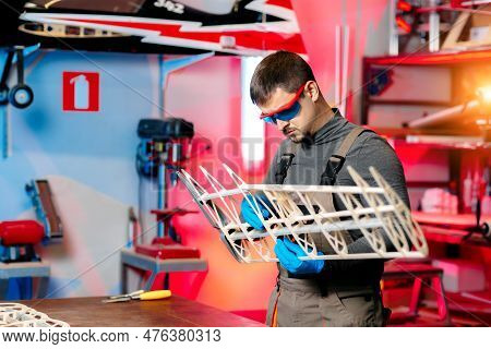 Male Engineer Or Technician Working On Drone Details In Lab. Aircraft Capable Of Gps Surveillance. C