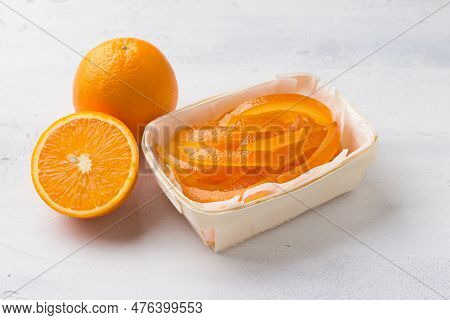 Wicker Birch Basket With Fresh Juicy Candied Oranges With Fresh Juicy Orange On A Light Gray Backgro