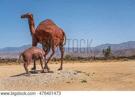 Borrego Springs, Ca, Usa - April 24, 2023: Brown Rusted Metal Prehistoric Giant Dromedary With Suckl