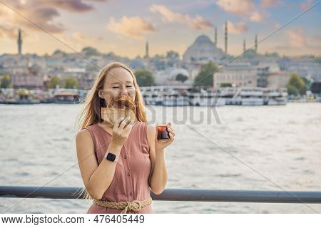 Woman In Istanbul Having Breakfast With Simit And A Glass Of Turkish Tea. Glass Of Turkish Tea And B