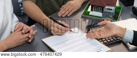 Panorama View Of Married Couple Signing House Loan Contract With Real Estate Agent. Client Customer 