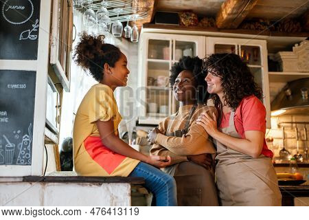 Multiethnic Homosexual Female Lesbian Couple With Daughter Spending Time Together At Home