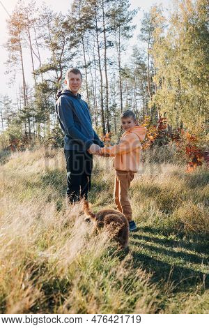Happy Fathers Day. Dad And Son On A Walk In The Forest In Sunny Weather. Family Leisure. The Father 