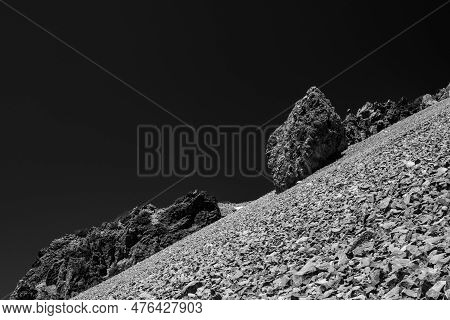 Black And White Of Scree Field And Large Boulders Below Dark Sky On Lassen Peak In Lassen Volcanic N