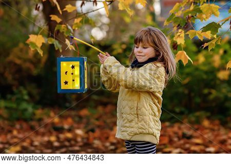 Little Preschool Kid Girl Holding Selfmade Traditional Lanterns With Candle For St. Martin Processio