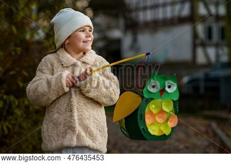 Little Preschool Kid Girl Holding Selfmade Traditional Owl Lanterns With Candle For St. Martin Proce