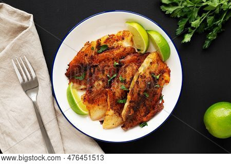 Homemade Pan Seared Tilapia On A Plate, Top View. Flat Lay, Overhead, From Above.