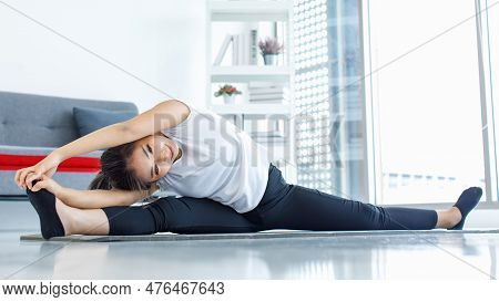 Asian Beautiful Healthy Fit Slim Sexy Female Sporty Athlete Model In Sportswear And Leggings Sitting