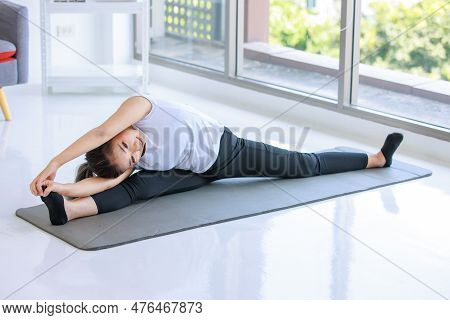 Asian Beautiful Healthy Fit Slim Sexy Female Sporty Athlete Model In Sportswear And Leggings Sitting