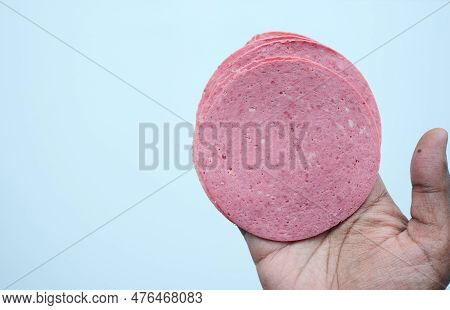 Salami Sausage Cut Into Thin Pieces On Hand