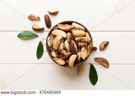 Fresh Healthy Brazil Nuts In Bowl On Colored Table Background. Top View Healthy Eating Bertholletia 