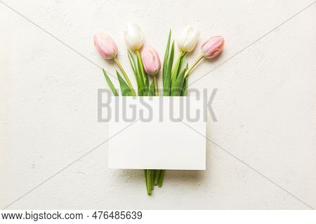 Composition With Blank Card And Beautiful Flowers Tulip On Coloredbackground. Top View With Space Fo