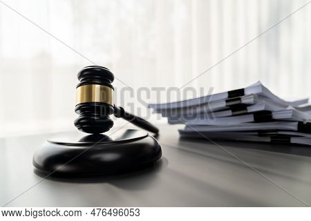 Black Wooden Gavel Hammer And Legal Document In Empty Law Firm Or Lawyer Office Background As Justic