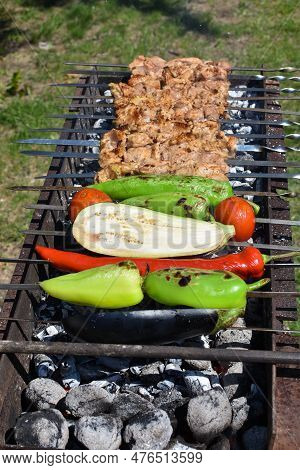 Barbecue, Cooking Meat On Skewers On The Grill With Coals, Vegetables