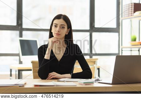 Pretty Female Worker Looks Forward At Interlocutor At Workplace In Office. Attentive Company Employe