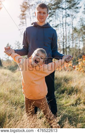 Happy Fathers Day. Dad And Son On A Walk In The Forest In Sunny Weather. Family Leisure. The Father 
