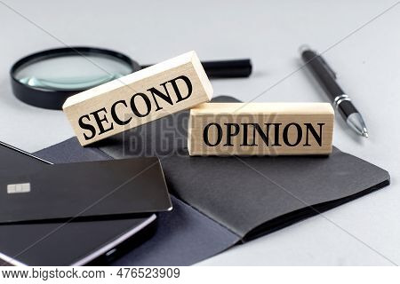 Second Opinion Text On A Wooden Block On Black Notebook , Business Concept
