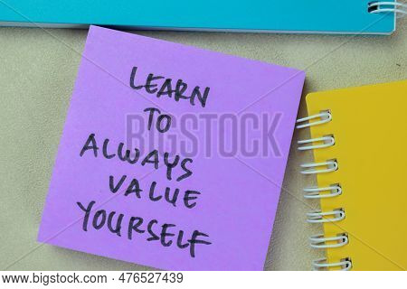 Concept Of Learn To Always Value Yourself Write On Sticky Notes Isolated On Wooden Table.