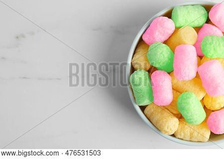Bowl With Colorful Corn Puffs On White Marble Table, Top View. Space For Text