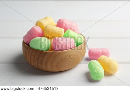 Bowl With Colorful Corn Puffs On White Wooden Table, Closeup