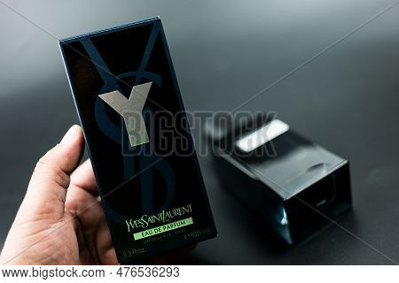Samut Prakan, Thailand - May 19, 2023 : Man Hand Holding A Box Of Perfumery Yves Saint Laurent Y Eau