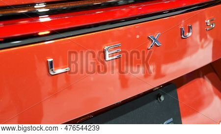 Red Lexus Car Brand Close Up View. Brand Of Japanese Automobiles Produce Premium Vehicles, Luxury Ca