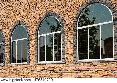 Beautiful Arched Windows In Building, View From Outdoors. White Painted Wood Arched Window In A Red