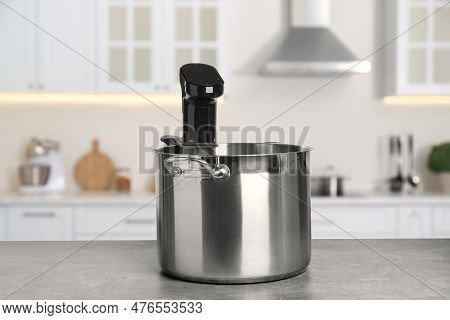 Sous Vide Cooker In Pot On Light Table In Kitchen. Thermal Immersion Circulator