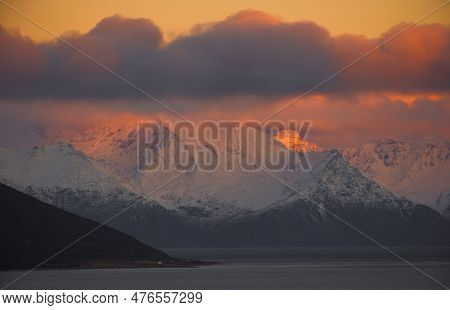 Dramatic Light And Clouds Over Snow Covered Mountain Peaks Of Northern Norway , Landscape And Nature