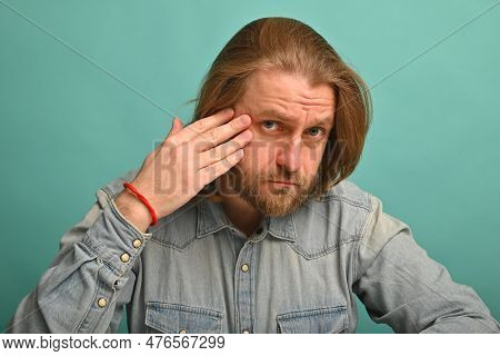 Man In Front Of Mirrror Looking At His Wrinkles