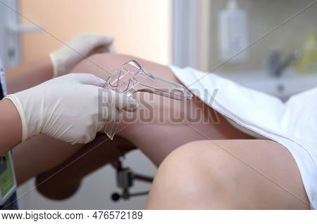 The Gynecologist Takes A Vaginal Swab For Bacterial Examination. Gynecological Chair. A Woman At The