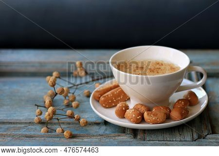 A Cup Of Warm Sahlab On A Rustic Wooden Background.