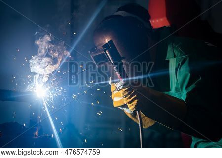Metal Welding Steel Works Using Electric Arc Welding Machine To Weld Steel At Factory. Metalwork Man
