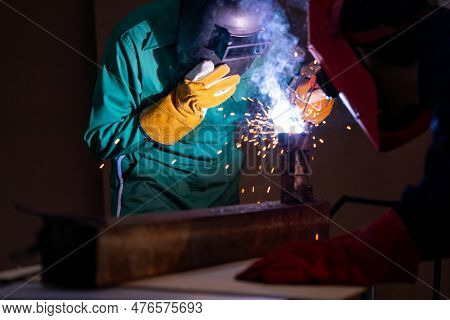 Metal Welding Steel Works Using Electric Arc Welding Machine To Weld Steel At Factory. Metalwork Man