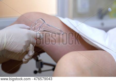 The Gynecologist Takes A Vaginal Swab For Bacterial Examination. Gynecological Chair. A Woman At The