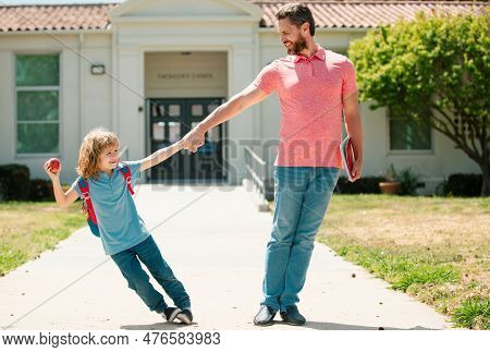 Father And Son Go To School, Education And Learning. Parent And Pupil Of Primary School Schoolboy Wi
