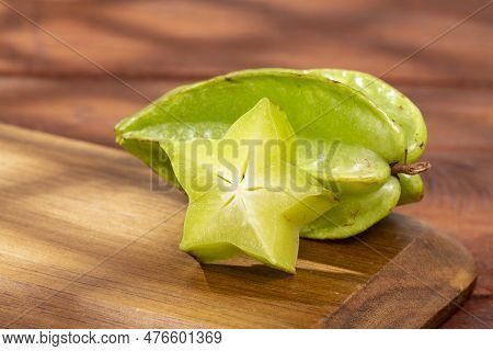 Star Fruit Or Carambola Green - Averrhoa Carambola; Photo On Wooden Background
