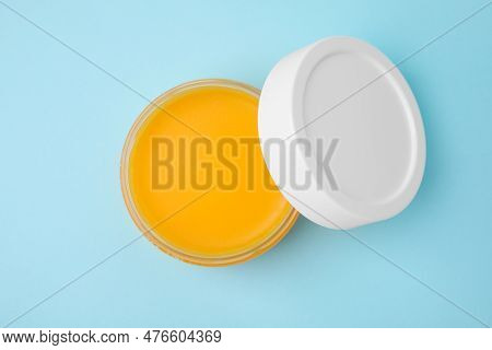 Open Jar Of Petrolatum On Light Blue Background, Top View