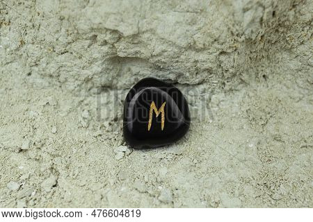 Black Rune Ehwaz On Stone Outdoors, Closeup