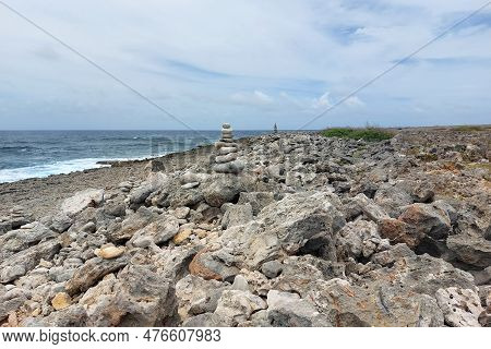A Pile Of Stones, Towers. A Pyramid Of Large Stones Stacked On The Seashore