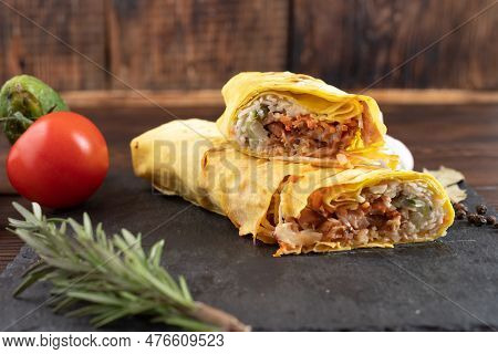 Shawarma Slice Close-up. Tomatoes And Next To Shawarma. Two Pieces Of Shawarma.