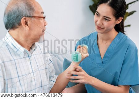 Contented Senior Patient Doing Physical Therapy With The Help Of His Caregiver. Senior Physical Ther