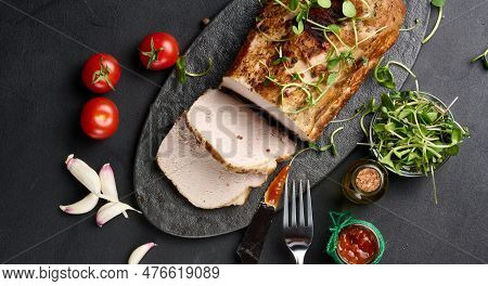 Baked Piece Of Pork Balyk On The Table With Spices. Tenderloin Cut Into Pieces, Top View