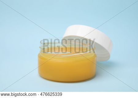 Open Jar Of Petrolatum On Light Blue Background, Closeup