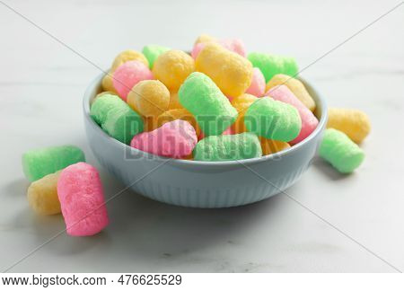 Bowl With Colorful Corn Puffs On White Marble Table, Closeup