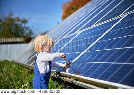 Boy Learning How Does Solar Panel Work. Small Kid Interested In Using Different Tools. Curious Boy H