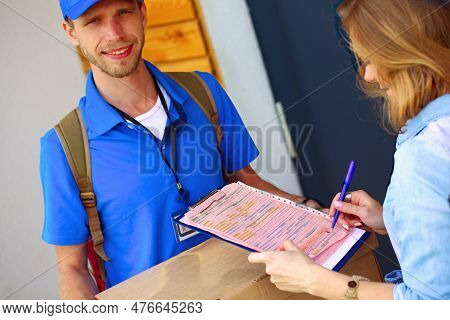Smiling Delivery Man In Blue Uniform Delivering Parcel Box To Recipient - Courier Service Concept. S