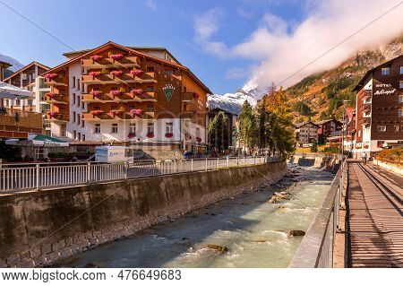 Zermatt, Switzerland - October 7, 2019: Town Street View In Famous Swiss Alps Ski Resort, River, Mat